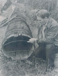 In this 1960’s photograph, Don Bledsoe examines a section of the 1919 wooden stave pipe.