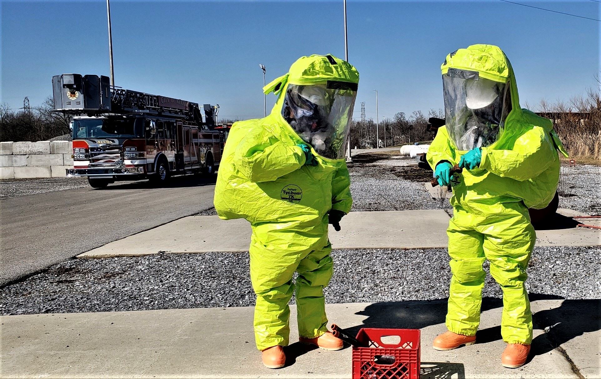 Two people in yellow hazmat suits