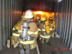 A team of firefighters combatting an interior fire.