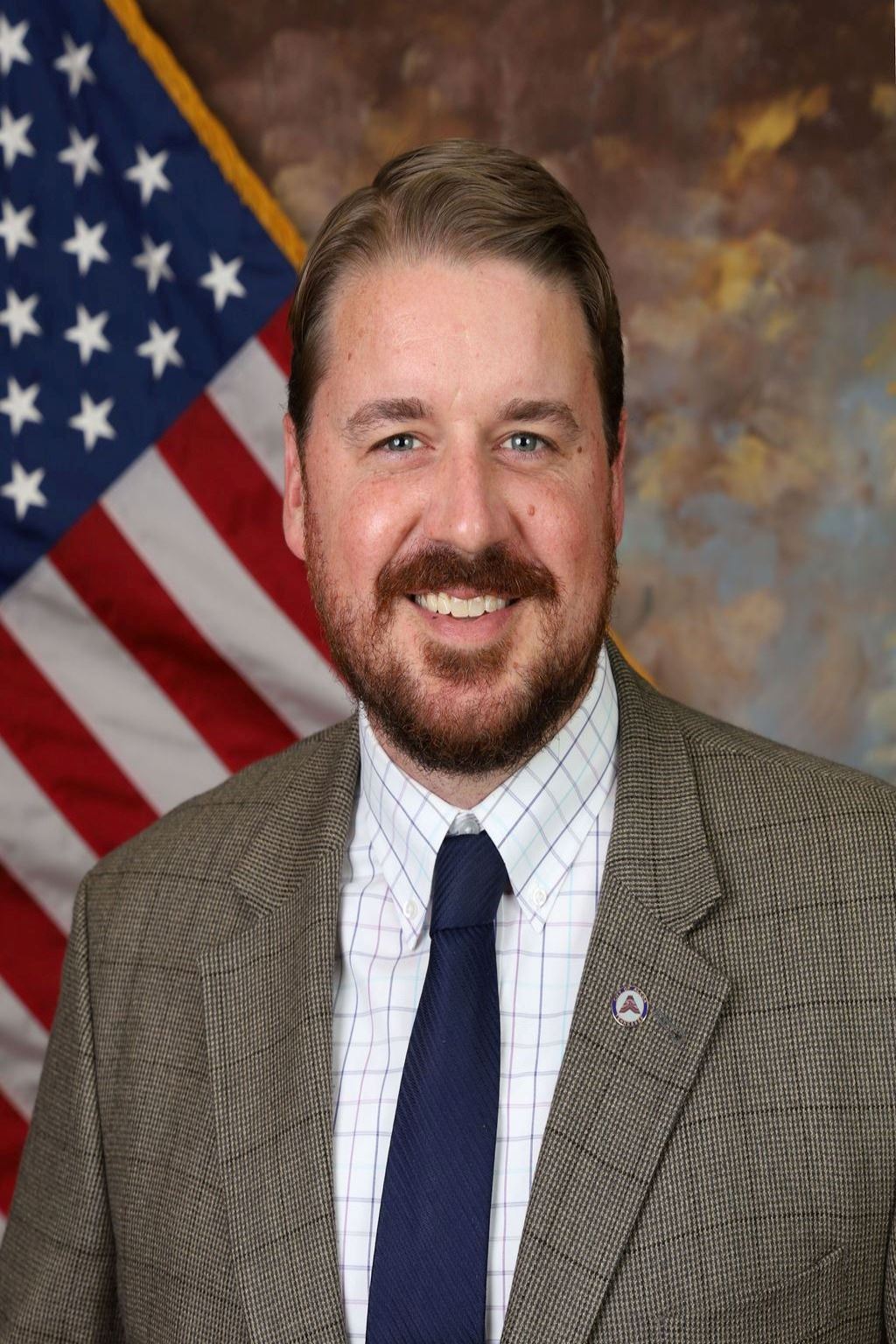 Bruce Applegate in front of American Flag background