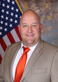 Josh Blair Commissioner Photo American Flag Background