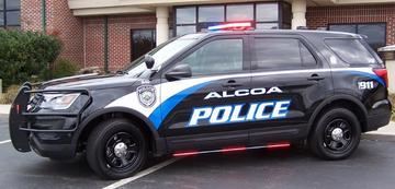 Side view of Alcoa Police Cruiser with red lights