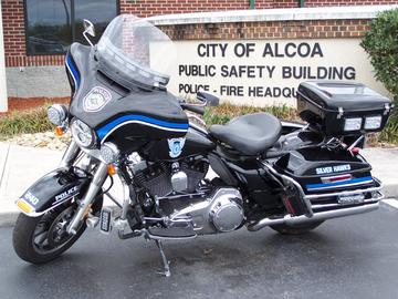 Side view of an Alcoa Police Department Motorcycle in front of the Public Safety Building