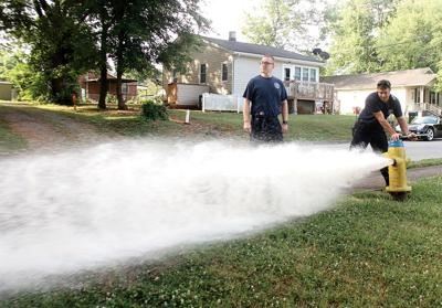 Firemen flushing fire hydrant